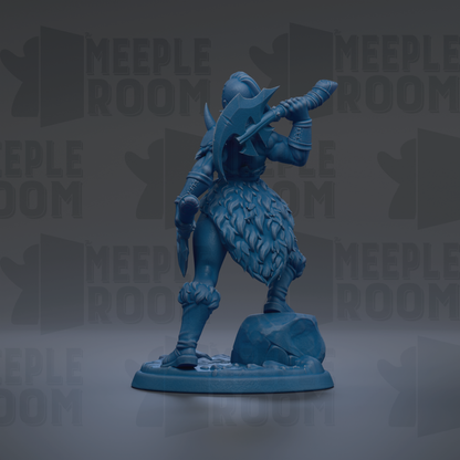 A blue figurine of a warrior standing on a rock, holding a weapon and wearing a helmet.