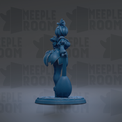 A blue figurine of a character with a large head and a round body, standing on a base and holding a small object in their hand.