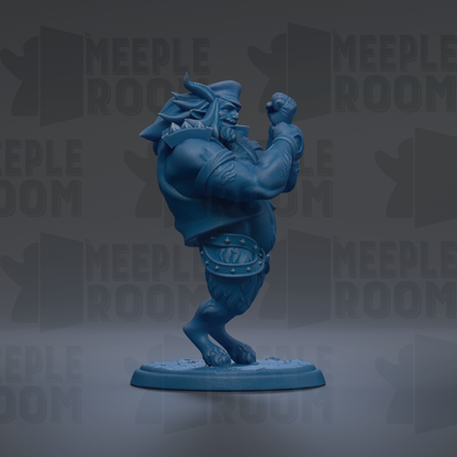 A blue figurine of a muscular, bearded character with a raised fist, standing on a base.