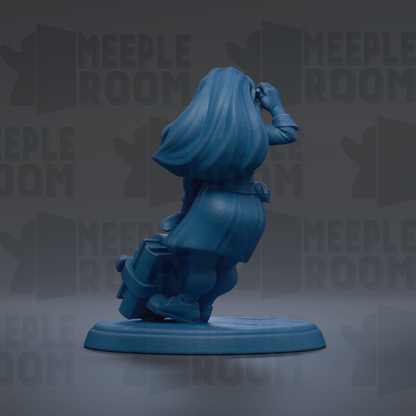 A blue figurine of a person with long hair is sitting on a base, facing away from the camera.