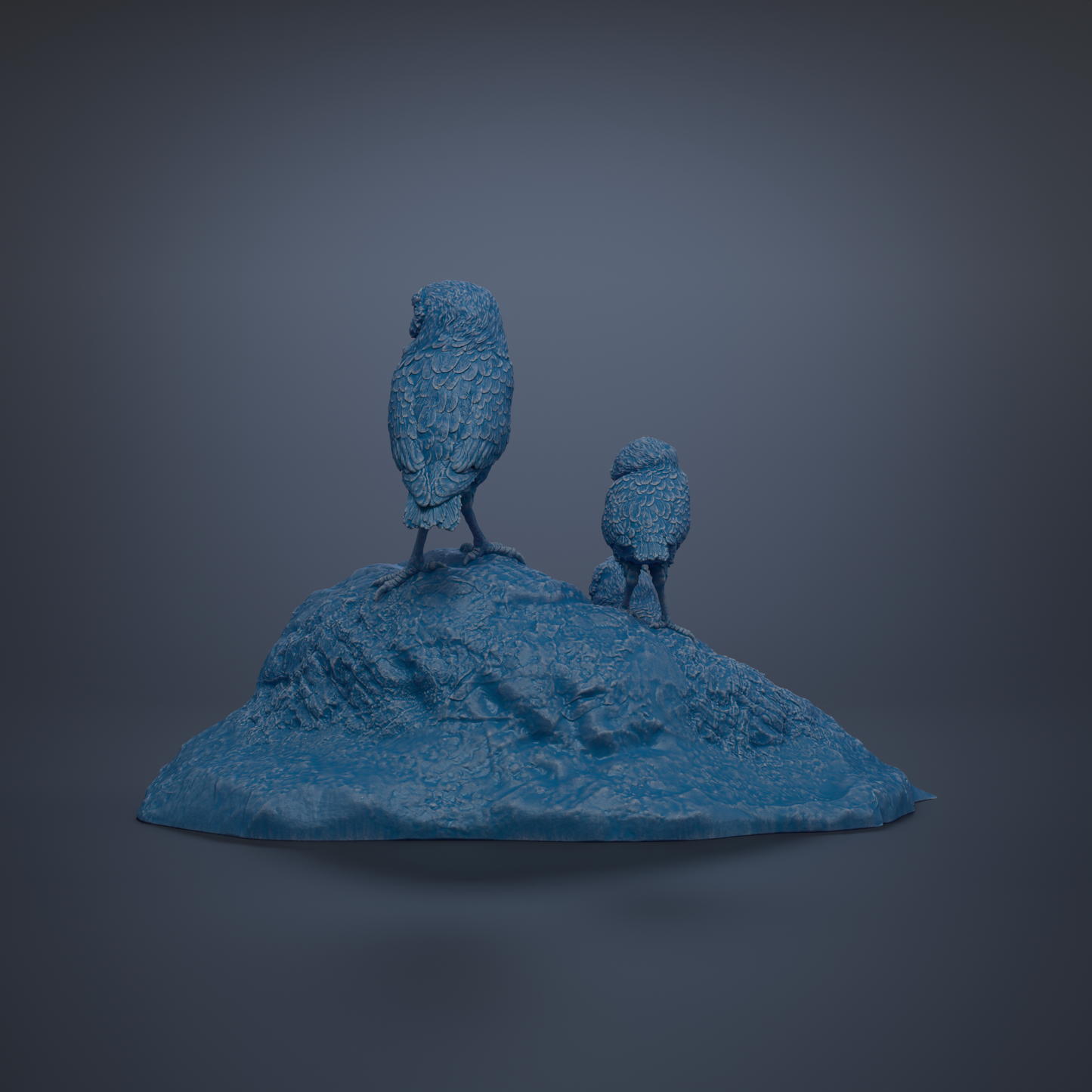 Two blue bird statues perched on a rocky outcrop against a dark background.