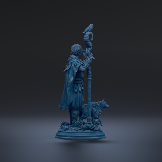 A blue statue of a man holding a staff and a bird, standing on a base with a wolf and a plant.