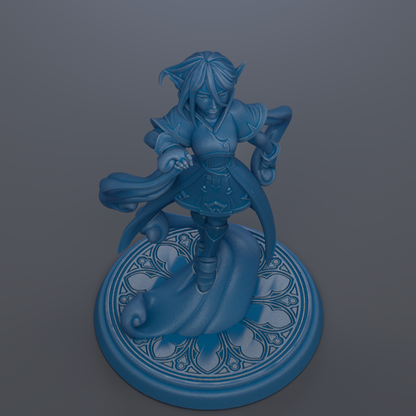 A blue figurine of a character with a flowing cape and a flowing skirt, standing on a decorative base with a floral pattern.