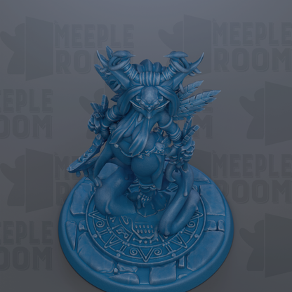 A blue figurine of a fantastical creature with horns and a long beard, sitting on a circular base with a geometric pattern.