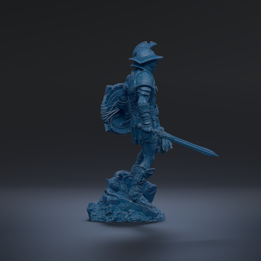 A blue statue of a warrior standing on a rock, holding a sword and shield.