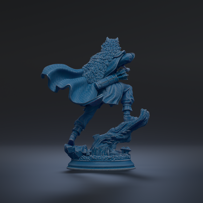 A blue statue of a person in a flowing robe and holding a weapon, standing on a rock formation against a dark background.