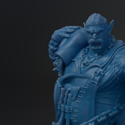 A close-up view of a blue, detailed statue depicting a fierce-looking monster or dragon-like creature with sharp teeth and claws.