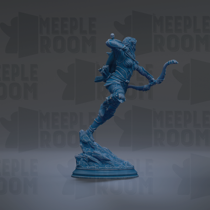 A blue statue of a figure with a bow and arrow, standing on a rock formation.