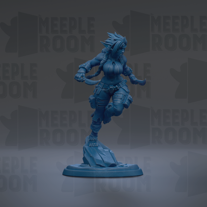 A blue figurine of a female character with spiky hair and a determined expression, standing on a rock.