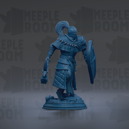A blue figurine of a knight in armor, holding a shield and sword, standing on a base.