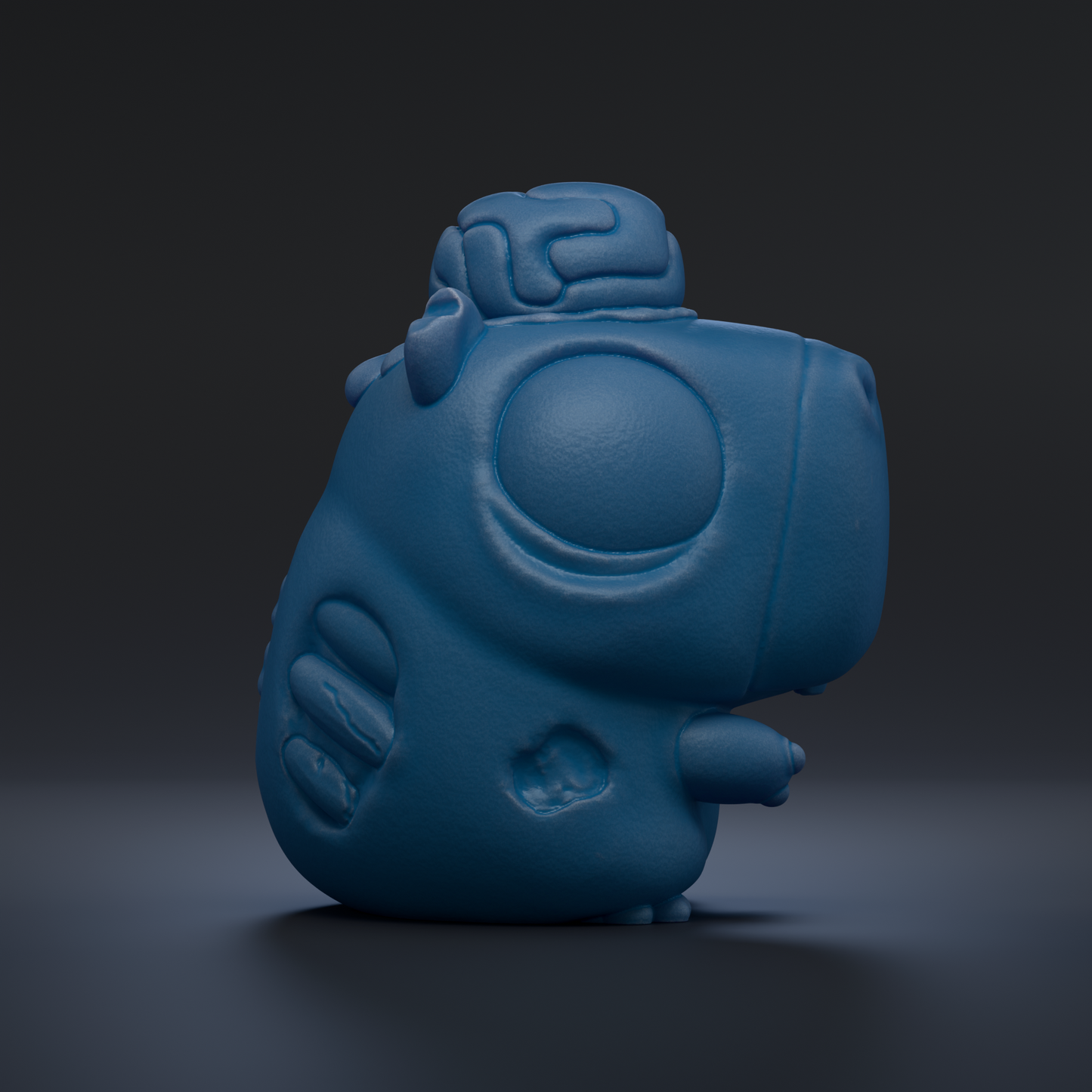 A blue, cartoon-like figurine with a brain-like shape on top, sitting on a dark surface.