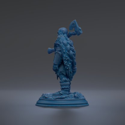 A blue statue of a warrior figure holding a sword and shield, standing on a base.