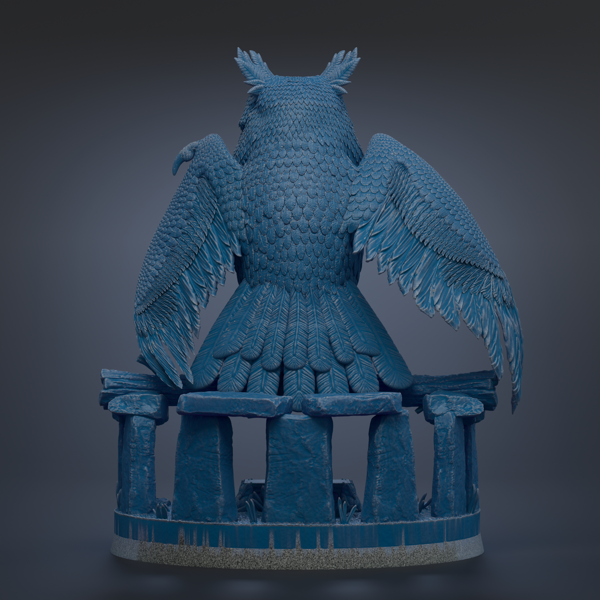 A large, detailed statue of an owl perched on a set of stone pillars.