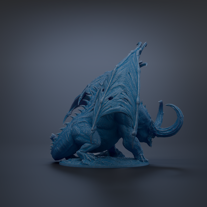 A blue dragon figurine with wings spread, standing on a base.