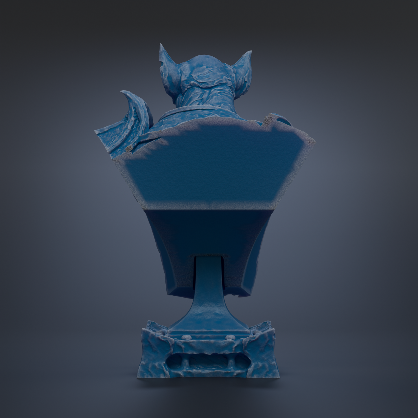 A blue bat statue with a textured surface and pointed ears, standing on a base.