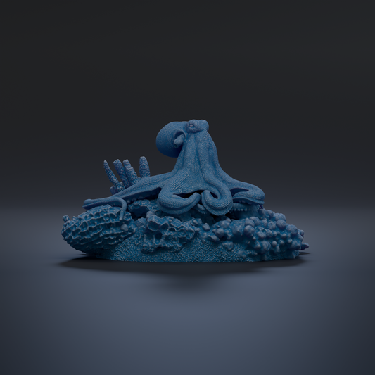 A blue octopus sculpture is displayed on a dark surface, surrounded by various marine life elements.