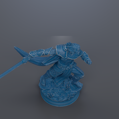A blue statue of a warrior figure with a sword in hand, standing on a rocky base.