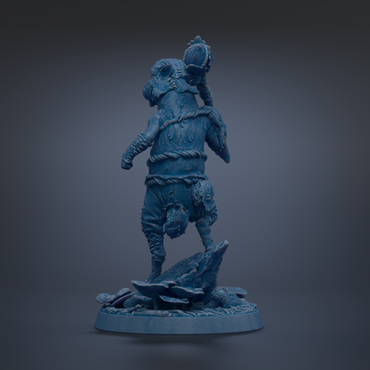 A blue, 3D-rendered statue of a fantastical creature with a large head and a smaller body, standing on a rock formation.
