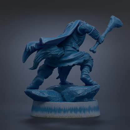 A blue statue of a warrior figure, holding a weapon and standing on a rock formation.