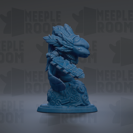 A blue figurine of a dragon-like creature with a large head and wings, holding a shield-like object, against a dark background with repeated text.