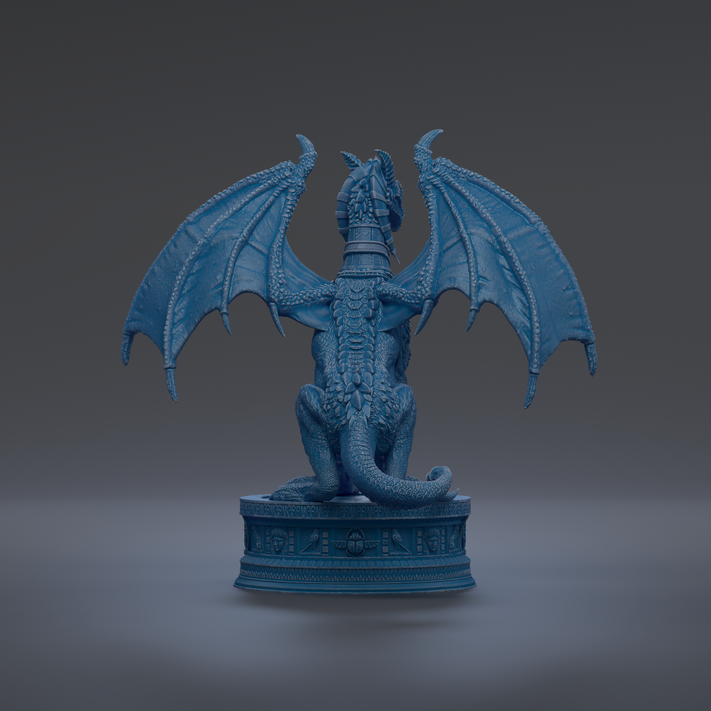 A blue dragon statue with wings spread, sitting on a pedestal.