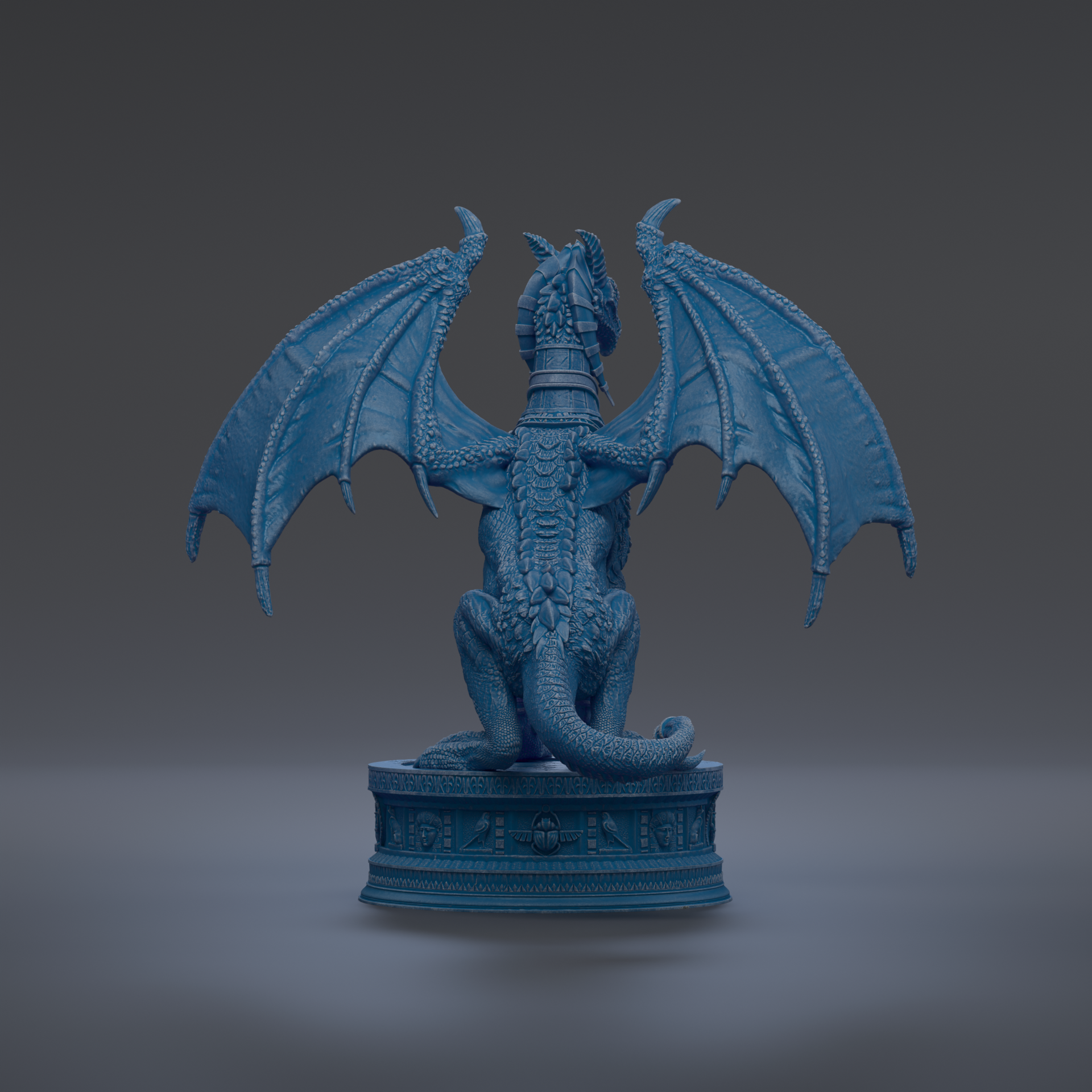 A blue dragon statue with wings spread, sitting on a pedestal.