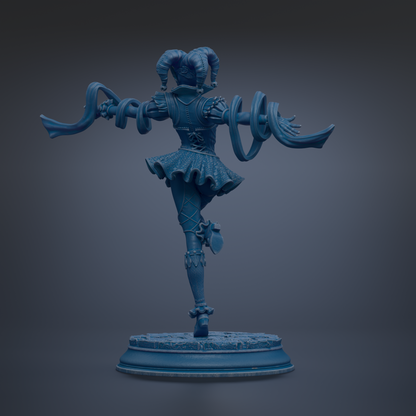 A blue statue of a figure with a flowing skirt and a large headdress, standing on a pedestal.