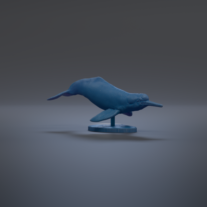 A blue plastic toy fish is displayed on a stand against a dark background.
