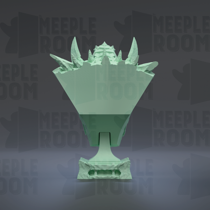 A green, sculpted trophy or award with sharp, jagged edges and a pointed top, set against a dark background with repeated text.
