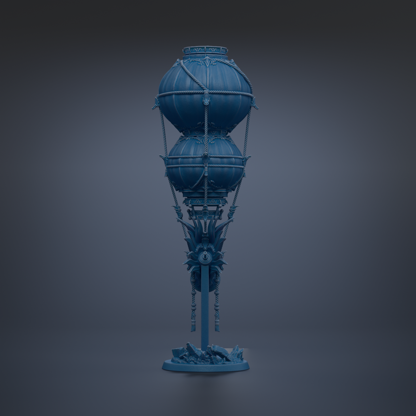 A blue, ornate lamp with a tall, cylindrical body and two spherical components, standing on a base with a decorative design.