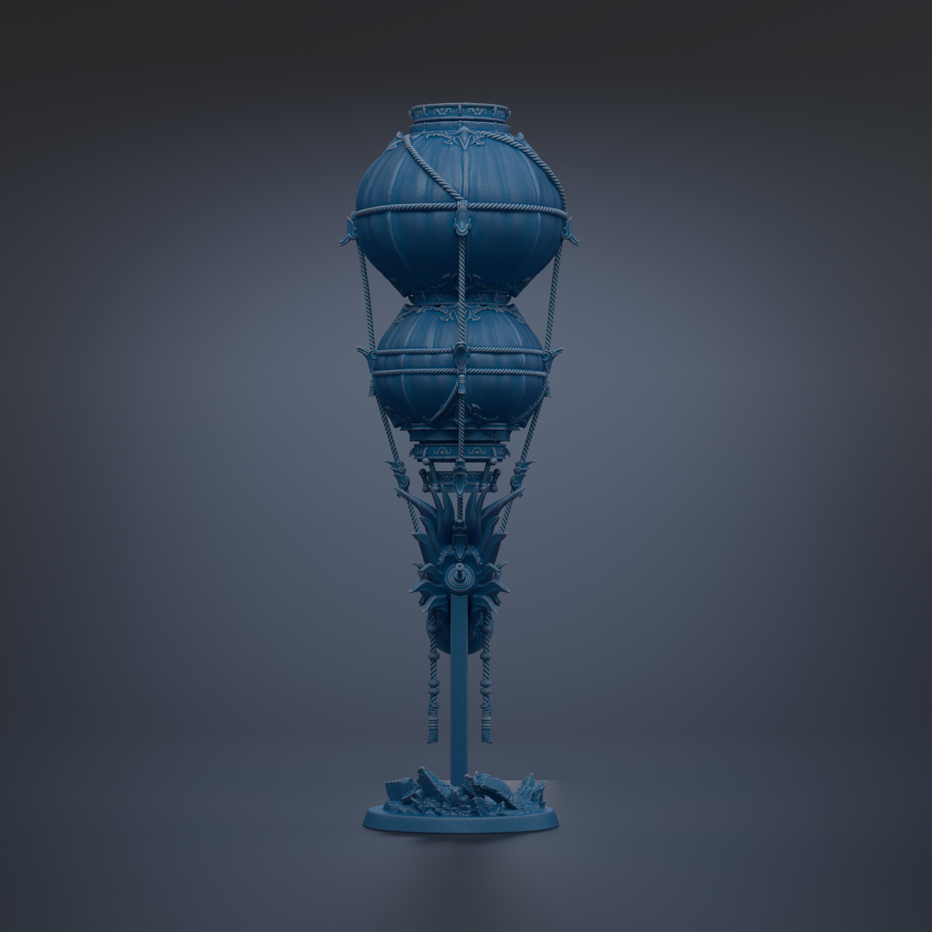 A blue, ornate lamp with a tall, cylindrical body and two spherical components, standing on a base with a decorative design.