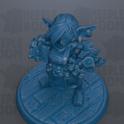 A blue figurine of a character with a large head and a small body, standing on a wooden base.