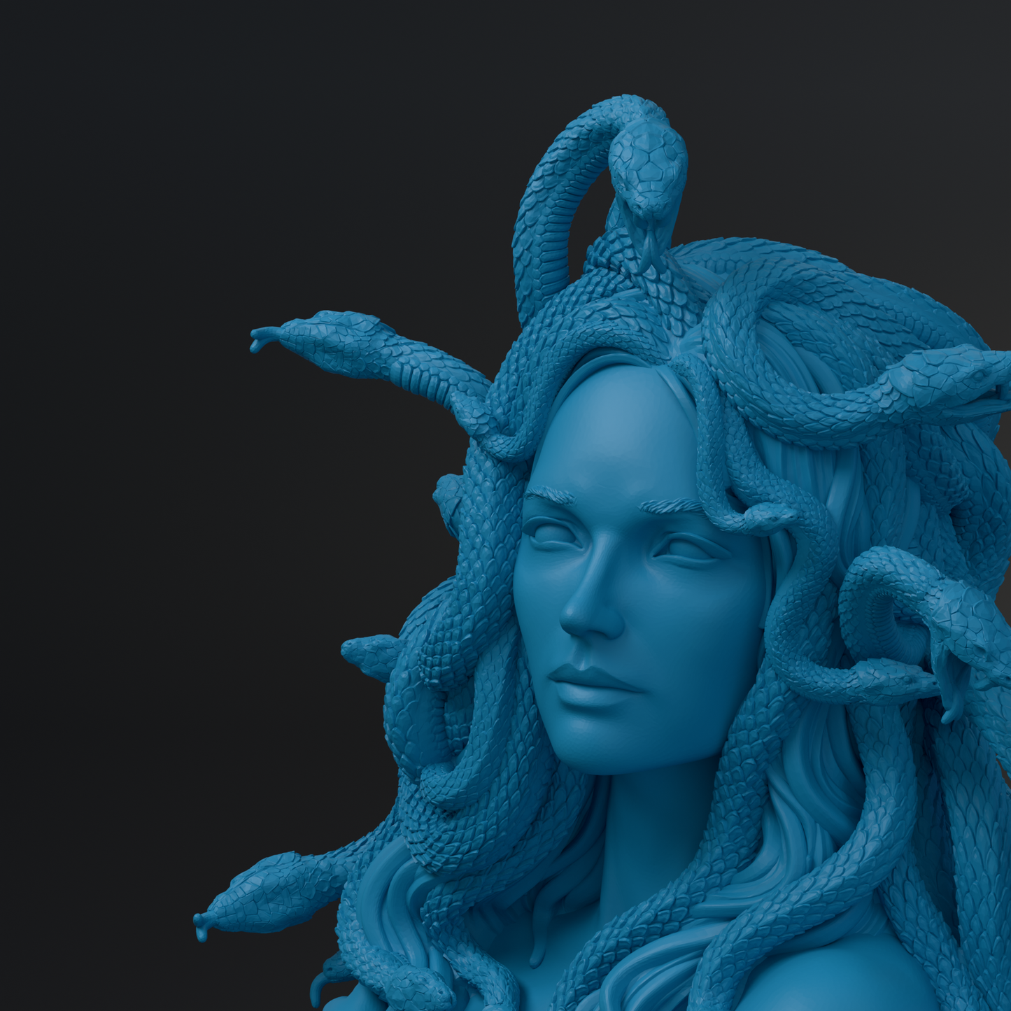 A close-up of a blue statue depicting a woman with snakes wrapped around her head and neck.