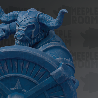 A blue, sculpted dragon-like creature with horns and a beard, sitting atop a shield or shield-like object.
