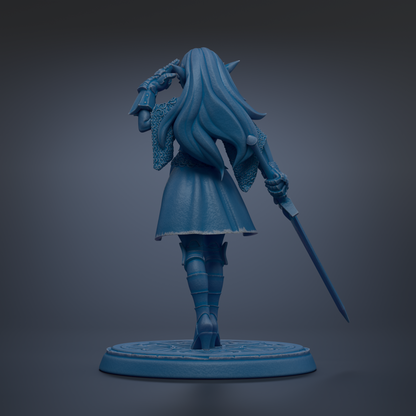 A blue statue of a woman with long hair and a flowing dress, holding a sword and standing on a circular base.