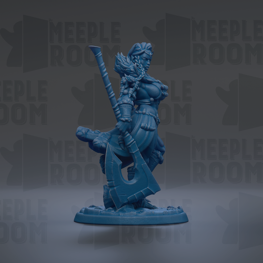 A blue figurine of a woman holding a large weapon, standing on a base.