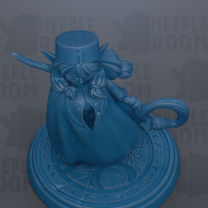 A blue figurine of a person with a hat and a staff, sitting on a circular base with a design.