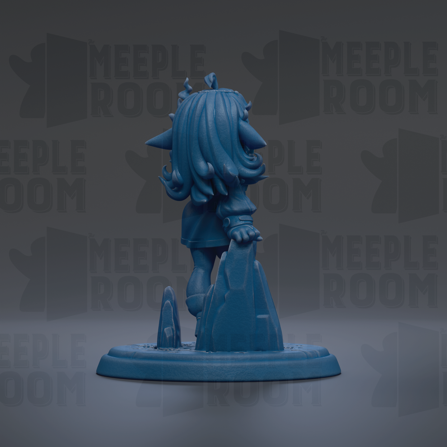 A blue figurine of a character with long hair and a pointed hat, standing on a rock formation.