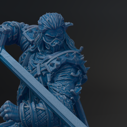 A close-up view of a blue, armored figure wielding a weapon, with a dark background.