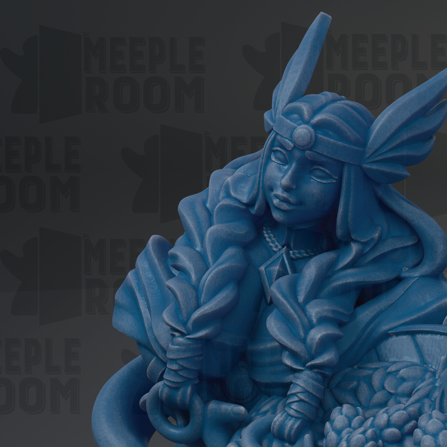 A blue statue of a woman with a headdress and flowing hair, sitting on a rock or pedestal.