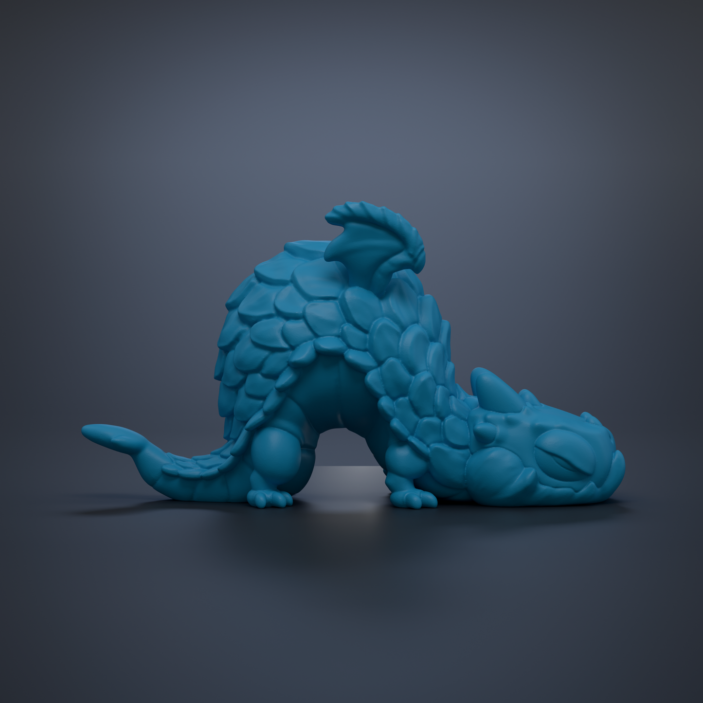 A blue, 3D-rendered dragon figurine is depicted in a sleeping position against a dark background.