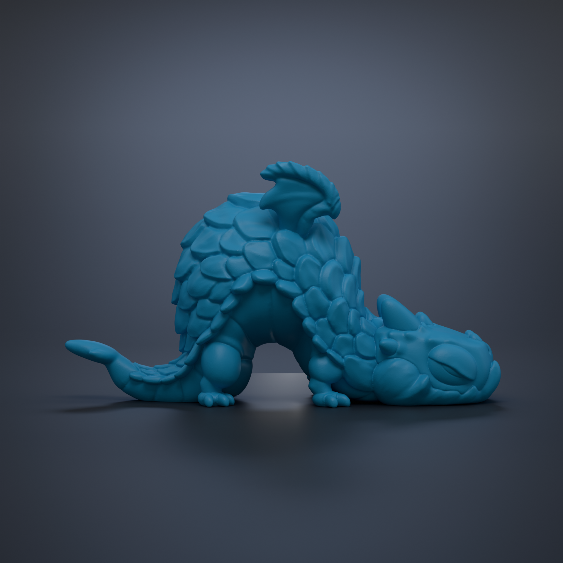 A blue, 3D-rendered dragon figurine is depicted in a sleeping position against a dark background.