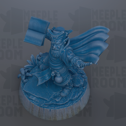 A blue figurine of a character with a beard and a cape, standing on a base and holding a book.