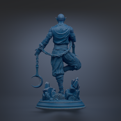 A blue statue of a figure holding a crescent moon and a chain, standing on a base with rocks and crystals.