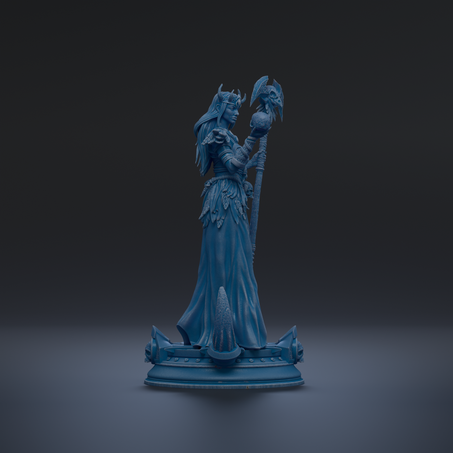 A blue statue of a woman holding a staff and a bird, standing on a pedestal.