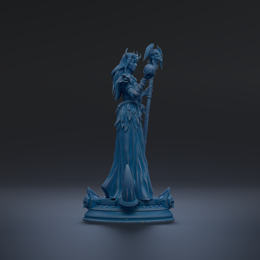 A blue statue of a woman holding a staff and a bird, standing on a pedestal.