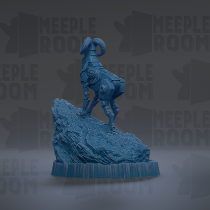 A blue, robotic-looking statue of a ram standing on a rock formation.