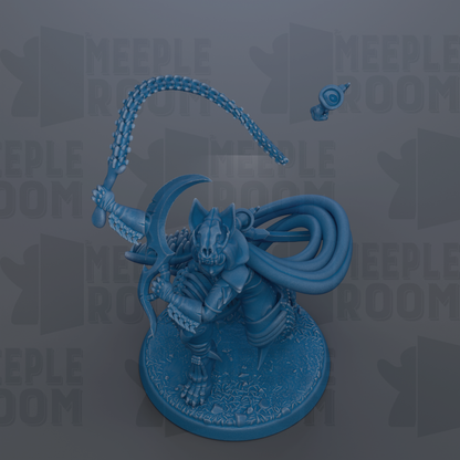 A blue figurine of a warrior-like character with a crescent moon on its head, holding a weapon and standing on a base.