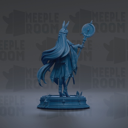 A blue statue of a figure with long hair and a headdress, holding a staff and standing on a pedestal.