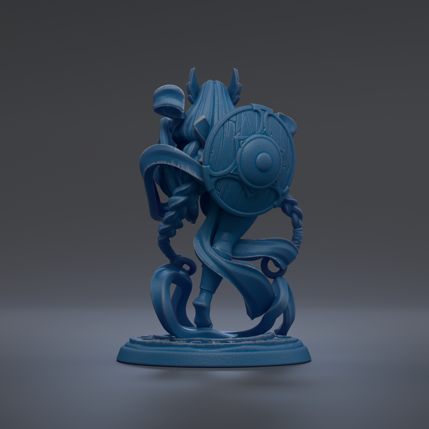 A blue, abstract sculpture with a shield-like design on the back, standing on a base.